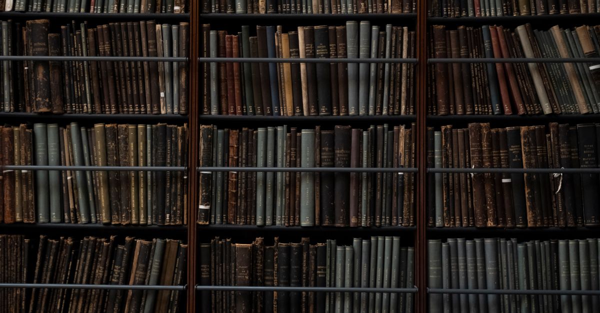 A close-up of vintage books on library shelves in London, showcasing an abundance of literary history.